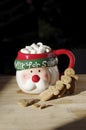 Hot chocolate Santa Clause cute mug with marshmallows, and gingerbread cookies on wooden table Royalty Free Stock Photo