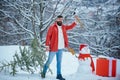 Funny Santa man posing with axe and Christmas tree. Hipster woodsman with Christmas tree. A handsome lumber with a beard Royalty Free Stock Photo