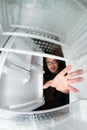 Funny scene of hungry young man opening the door of the fridge Royalty Free Stock Photo