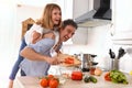 Man cooking and daughter on their backs at home