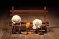 Funny scene with popcorn figures on a wooden table, sitting on a bench