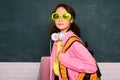 Funny school teen wearing eyeglasses, child studio portrait. Education concept. Young teenager schoolgirl with school