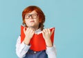 Funny schoolboy with book making face Royalty Free Stock Photo