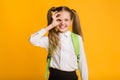 Funny Schoolgirl Gesturing Okay Sign Standing Over Yellow Background, Studio