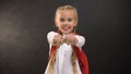 Funny schoolgirl showing wooden cubes with math word, exact sciences lesson