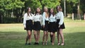 Funny schoolgirls posing and goofing around in a meadow.