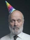 Funny senior bald man with party hat