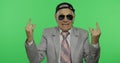 Funny senior businessman in sunglasses show sign of the horns with his hands