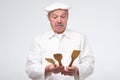 Funny senior man chef with wooden kitchen tools Royalty Free Stock Photo