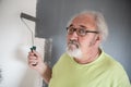 Funny senior man painting the wall Royalty Free Stock Photo