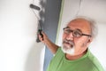 Funny senior man painting the wall Royalty Free Stock Photo