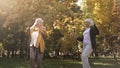 Funny senior women enjoying weather, dancing and having fun in warm autumn park Royalty Free Stock Photo