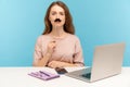 Funny serious woman office employee sitting at workplace, covering lips with fake paper moustache, imitating strict boss