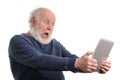 Funny shocked senior man using tablet computer isolated on white