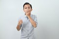 Funny shocked and surprised face of asian Indonesian man, open wide mouth say wow, on isolated backgorund Royalty Free Stock Photo