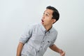 Funny shocked and surprised face of asian Indonesian man, open wide mouth say wow, on isolated backgorund Royalty Free Stock Photo