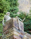 Funny Skeleton sits on Stone Wall Royalty Free Stock Photo