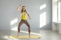 Funny skinny fitness nerd dancing, jumping and having fun during sports workout at home Royalty Free Stock Photo