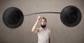 Funny skinny guy lifting weights Royalty Free Stock Photo