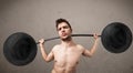 Funny skinny guy lifting weights Royalty Free Stock Photo