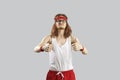 Funny skinny nerd in sportswear giving a thumbs-up and motivating you to exercise Royalty Free Stock Photo