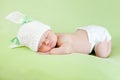 Funny sleeping newborn baby. Bunny cap on her head