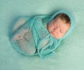 Funny sleeping newborn on blue blanket and in diaper Royalty Free Stock Photo