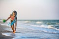 Girl playing with waves kicking and spinning under the summer sun enjoying the vacation Royalty Free Stock Photo