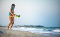 Girl playing with waves kicking and spinning under the summer sun enjoying the vacation Royalty Free Stock Photo