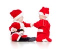 Funny small babies in Santa Claus clothes