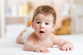 Funny small baby lying on the belly and smiling Royalty Free Stock Photo