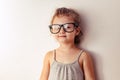 Funny smart kid girl in fashion glasses looking on empty copy space. Closeup Royalty Free Stock Photo