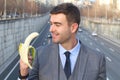 Funny smiley businessman holding a banana Royalty Free Stock Photo