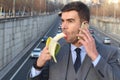 Funny smiley businessman holding a banana while calling by phone Royalty Free Stock Photo