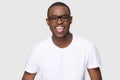 Funny smiling African American man in glasses showing tongue Royalty Free Stock Photo