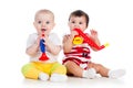 Funny smiling babies girls with musical toys Royalty Free Stock Photo