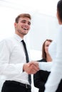 Funny smiling businessman shaking hands with his partner. Royalty Free Stock Photo