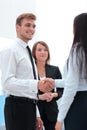 Funny smiling businessman shaking hands with his partner. Royalty Free Stock Photo