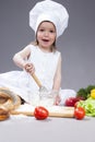 Funny Smiling Caucasian Girl In Cook Uniform Making a Mix of Flour Royalty Free Stock Photo