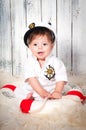 Funny smiling little boy dressed as a sea captain in naval cap. Marine decor, lifebelt Royalty Free Stock Photo