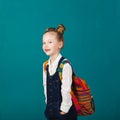 Funny smiling little girl with big backpack jumping and having f Royalty Free Stock Photo