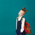 Funny smiling little girl with big backpack jumping and having f Royalty Free Stock Photo