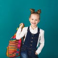 Funny smiling little girl with big backpack jumping and having f Royalty Free Stock Photo