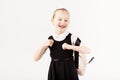 Funny smiling little girl with big backpack jumping and having f Royalty Free Stock Photo