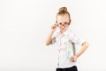 Funny smiling little girl imitates a strict teacher against whit Royalty Free Stock Photo
