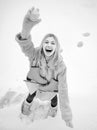 Funny smiling young woman in wintertime outdoor. Wearing funny hat plaid scarf and coat. Happy winter fun woman. Winter Royalty Free Stock Photo
