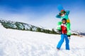 Funny snowboarder holding girl on his shoulders