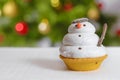 Snowman cookie and christmas tree behind Royalty Free Stock Photo