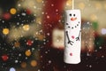 Funny snowman made of marshmallows against blurred Christmas tree, closeup. Space for text Royalty Free Stock Photo