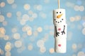 Funny snowman made of marshmallows against blurred festive lights, closeup. Space for text Royalty Free Stock Photo